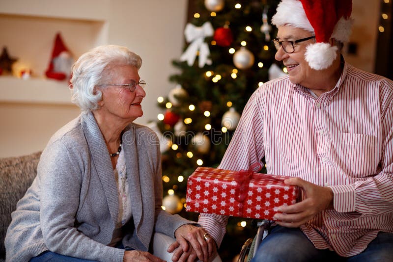 Senior man and woman with Christmas gift royalty free stock photo Senior man and woman with Christmas gift royalty free stock photo