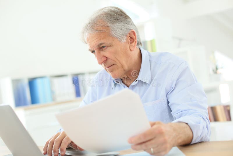 Senior man working on laptop