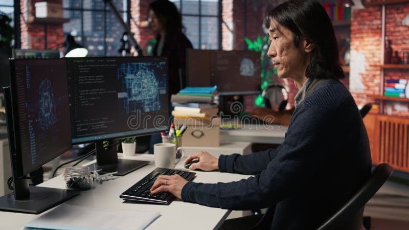 Senior manager drinks coffee while working in software development agency stock footage