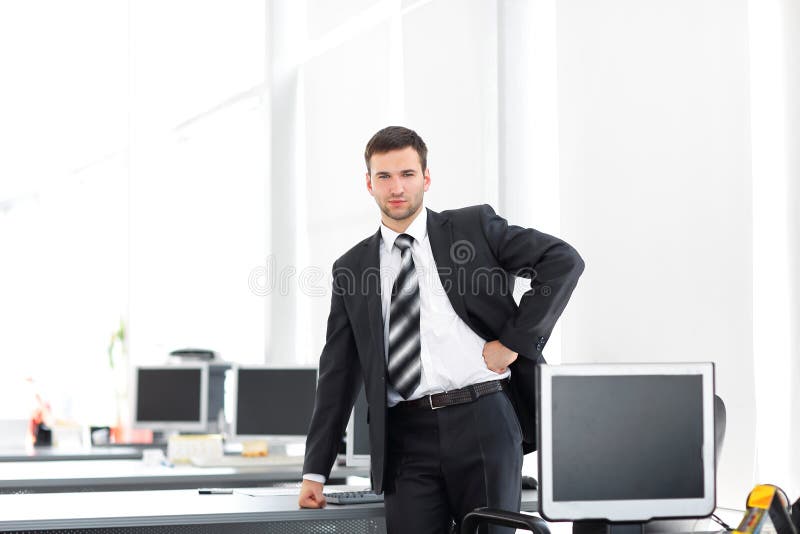 Senior Manager Standing in a Modern Office before the Start of the