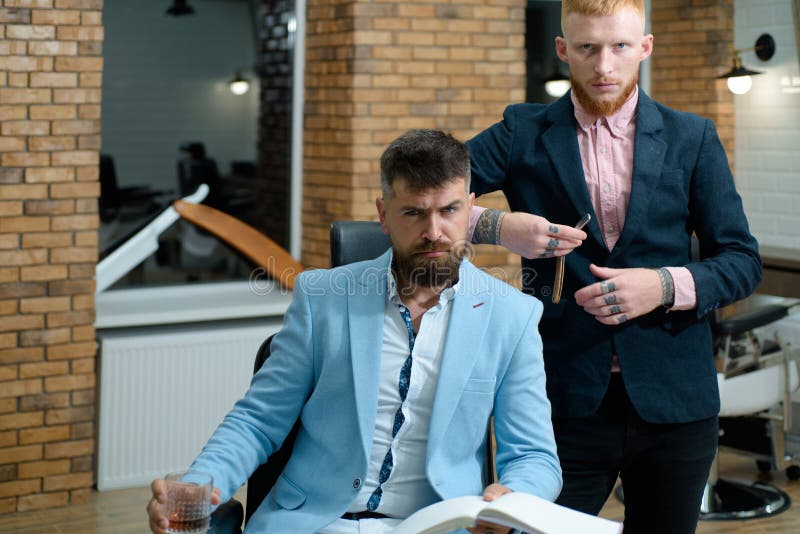 Senior man visiting hairstylist in barbershop. Professional hairstylist in barbershop interior. Hair Preparation is just stock photography Senior man visiting hairstylist in barbershop. Professional hairstylist in barbershop interior. Hair Preparation is just stock photography