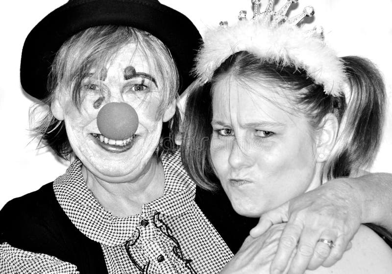 A close up portrait of a mature middle aged mother having fun with her teenage daughter at a fancy dress party. Young at heart and never too old to be silly and have some good old fashioned fun. A close up portrait of a mature middle aged mother having fun with her teenage daughter at a fancy dress party. Young at heart and never too old to be silly and have some good old fashioned fun.