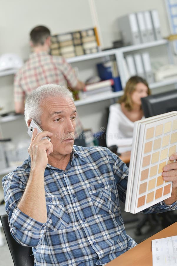 Senior office worker looks confused stock images