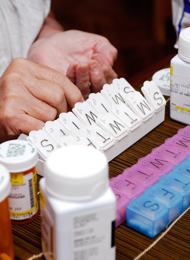Senior organizing pill box stock photo. Image of industry 3173616