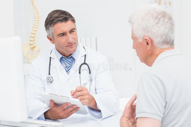 Senior patient sharing problems with doctor stock photos