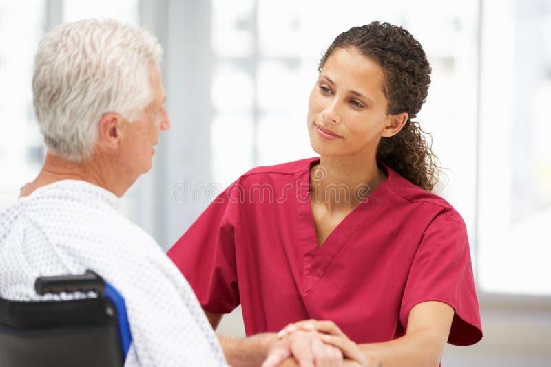 Senior patient with young doctor stock photos