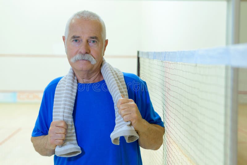 Senior player tennis looking at camera royalty free stock photo