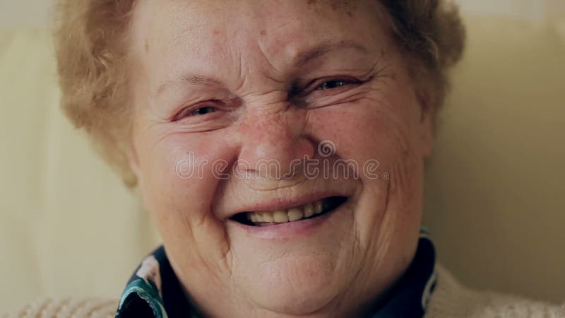 Senior portrait, happy old woman with eyeglasses smiling and looking at camera.