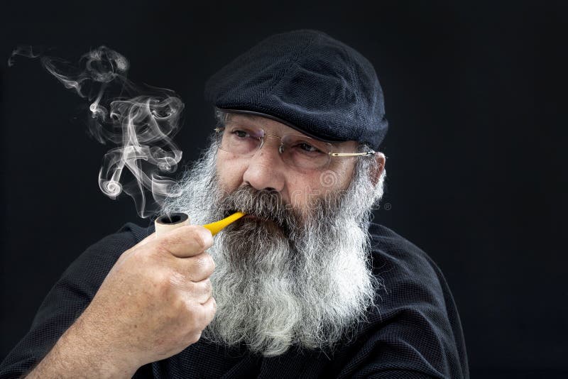 Senior portrait with white beard and pipe royalty free stock photography