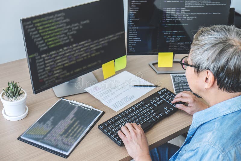 Senior Professional programmer working at developing programming and website working in a software develop company office, writing royalty free stock image Senior Professional programmer working at developing programming and website working in a software develop company office, writing royalty free stock image