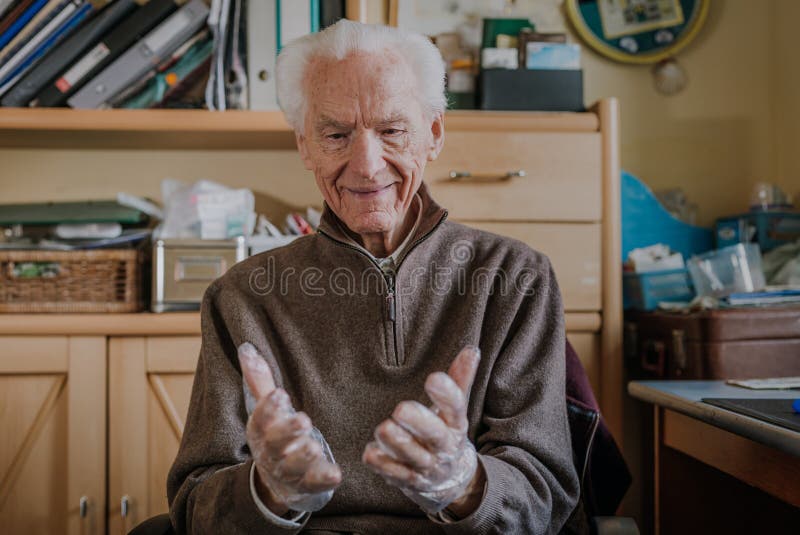 Elderly Man Puts on Disposable Protective Gloves Stock Image Image of