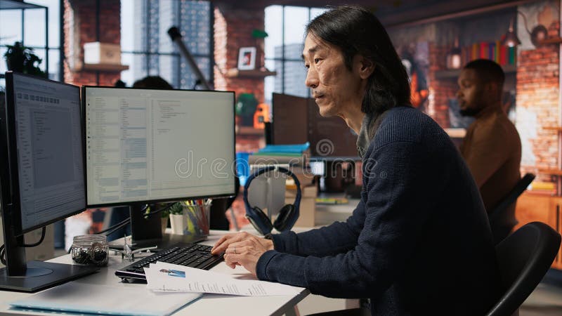 Senior tech startup HR recruiter identifying candidates for job, reviewing CVs royalty free stock image