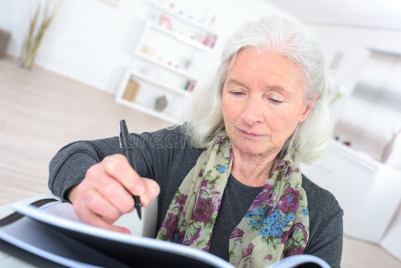 Senior therapist writing notes on sofa in office. Advice. Therapist taking notes stock images, royalty-free photos and pictures