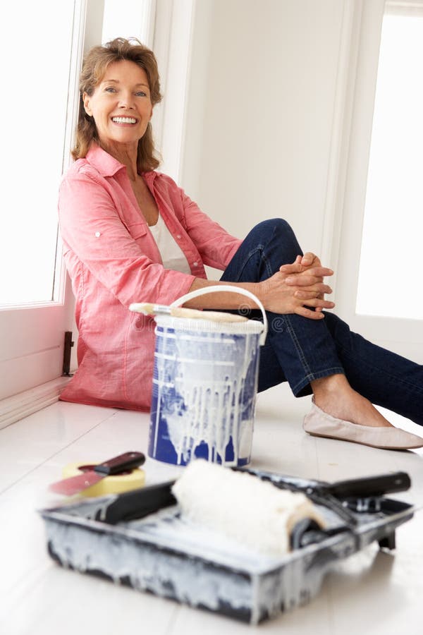 Senior woman decorating house stock photo Senior woman decorating house stock photo