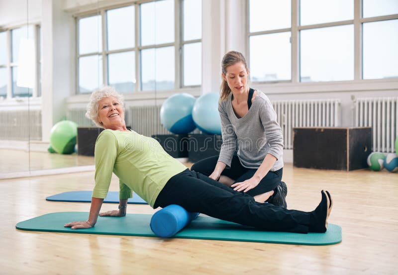 Senior woman doing pilates with foam roller royalty free stock images Senior woman doing pilates with foam roller royalty free stock images