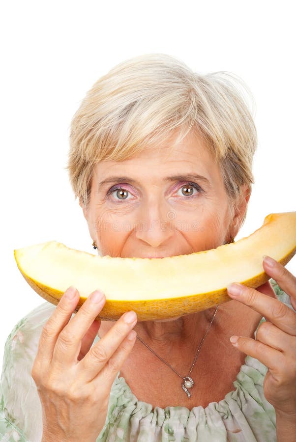 Senior woman eating melon