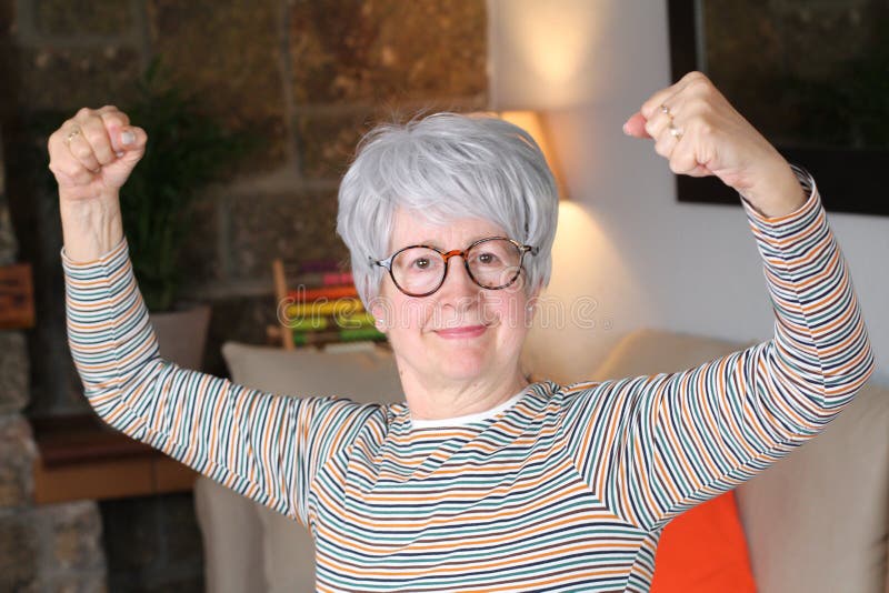 Senior Woman Flexing Biceps at Home Stock Image - Image of arrogant ...