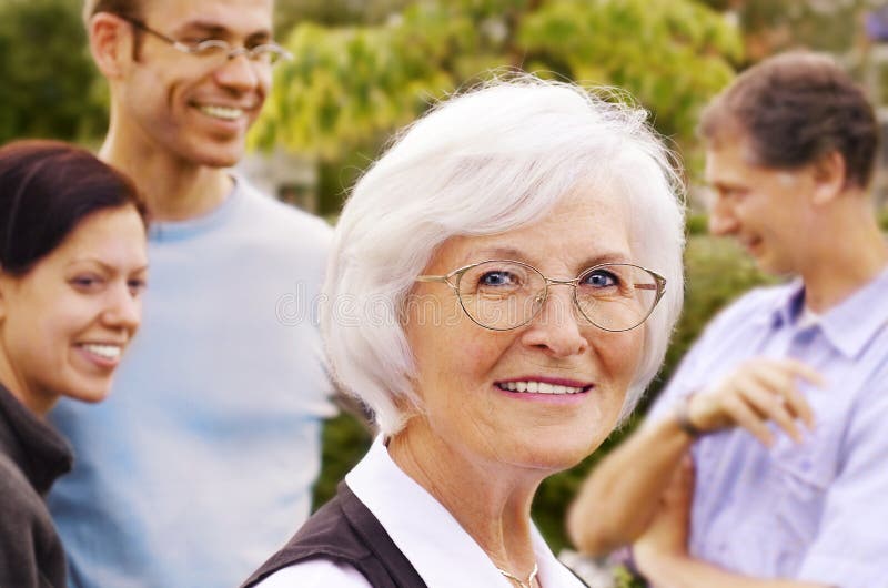 Senior woman in front of young people group