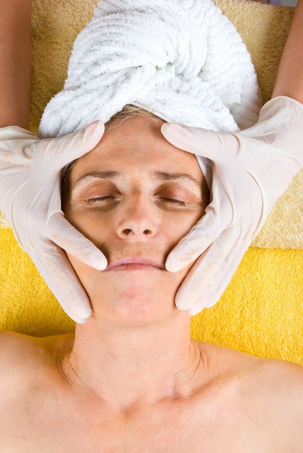 Senior woman having a cosmetic treatment stock photo