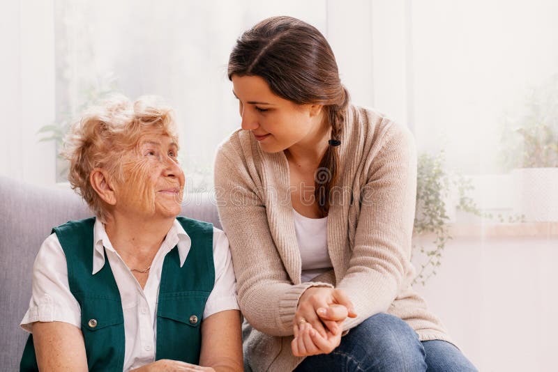 Senior woman and helpful volunteer at nursing home royalty free stock image