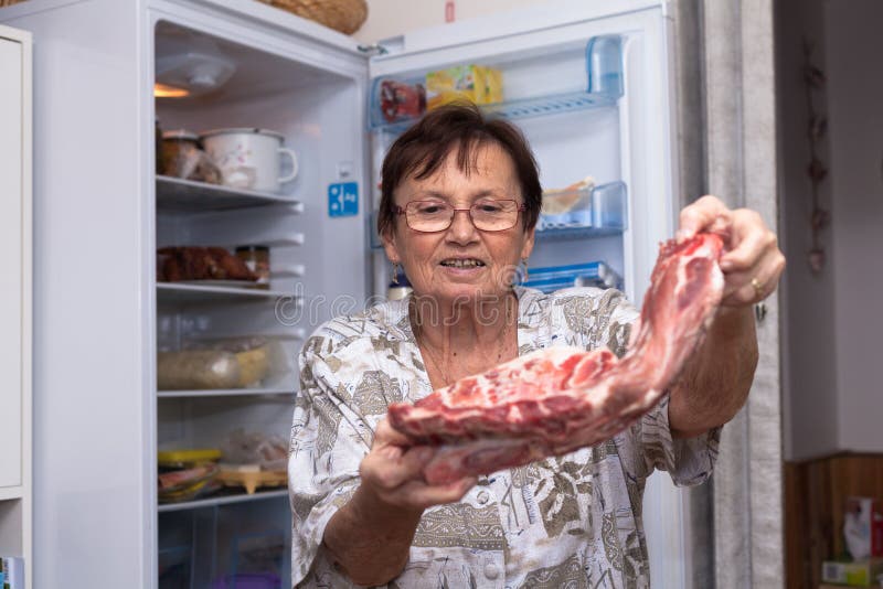 Senior woman holding raw pork ribs stock image Senior woman holding raw pork ribs stock image