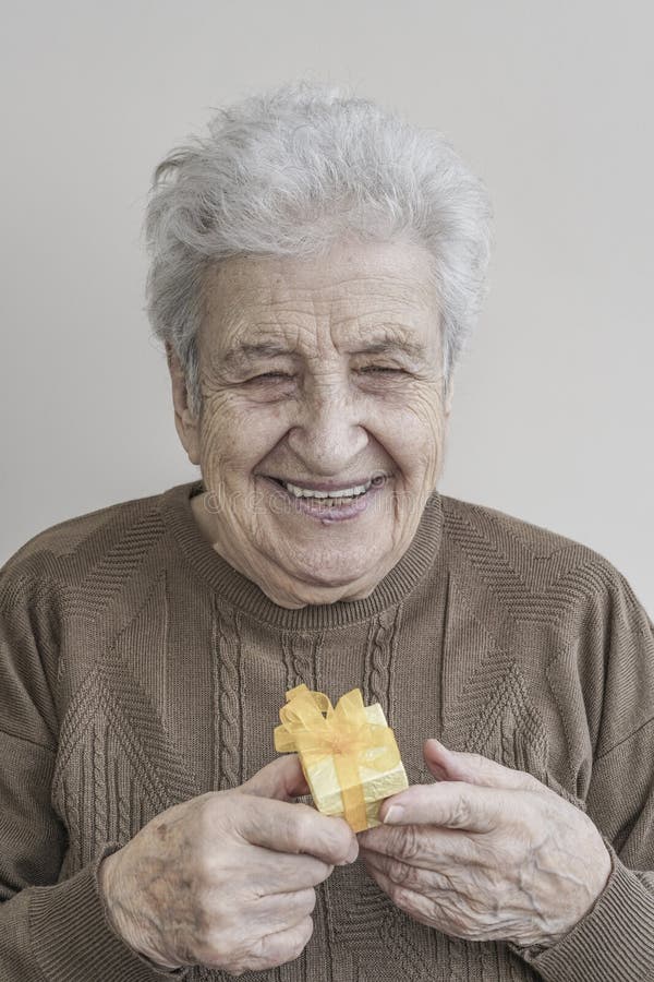 Senior woman holding a small gift