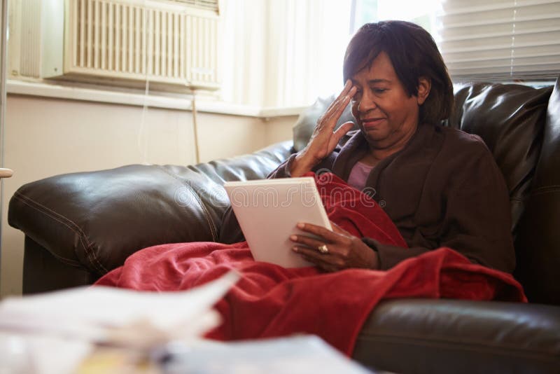 Senior Woman Keeping Warm Under Blanket With Photograph royalty free stock photo Senior Woman Keeping Warm Under Blanket With Photograph royalty free stock photo