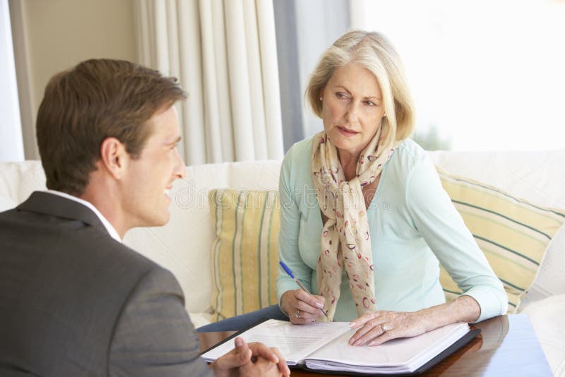 Senior Woman Meeting With Financial Advisor At Home stock photos Senior Woman Meeting With Financial Advisor At Home stock photos
