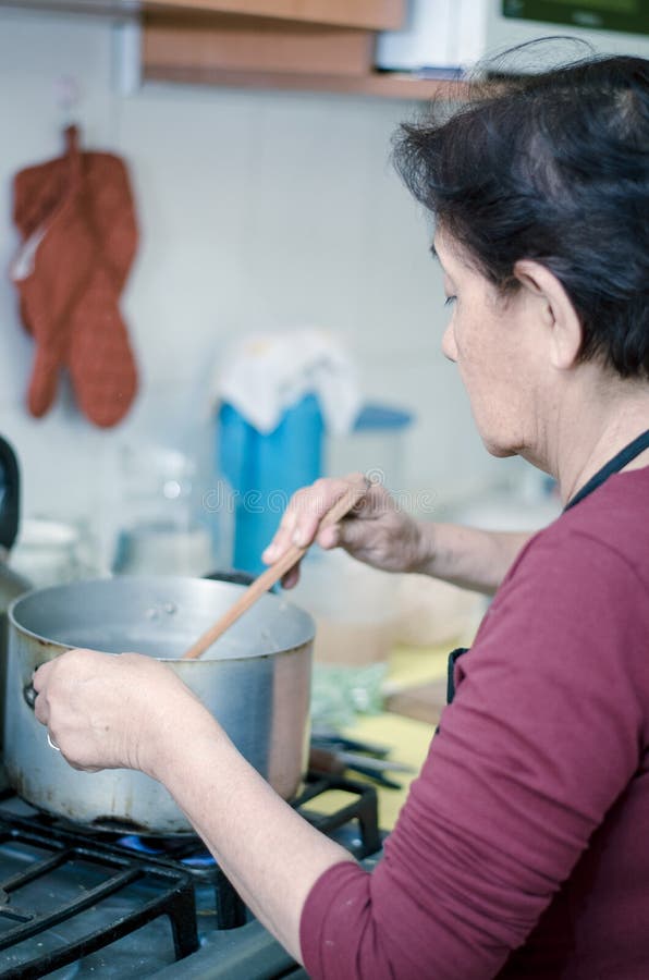 Senior woman preparing healthy food from fresh vegetables stock images Senior woman preparing healthy food from fresh vegetables stock images