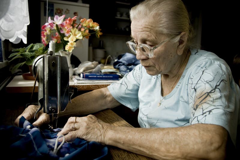 Senior woman during sewing stock photo. Image of machine 24442740