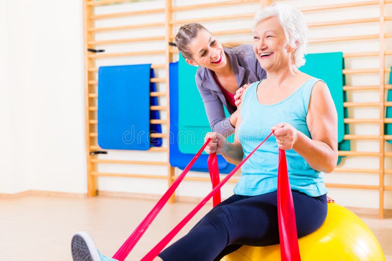 Senior woman with stretch band at fitness stock photo Senior woman with stretch band at fitness stock photo