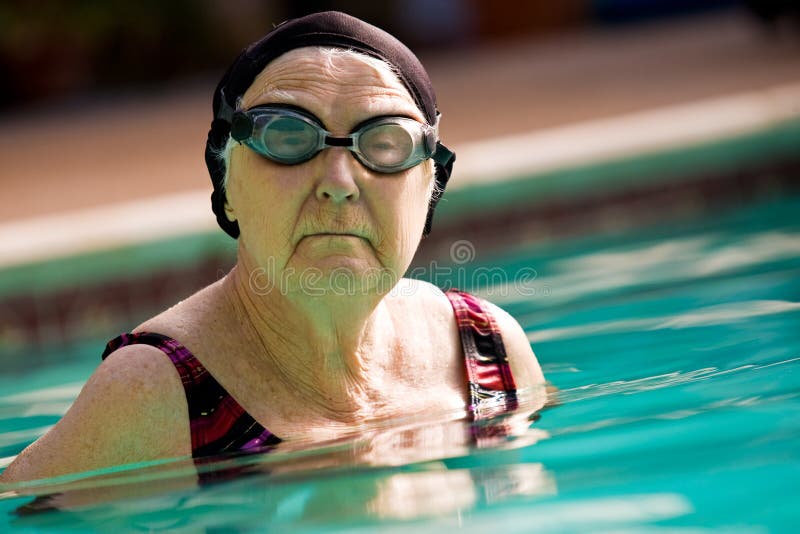 Senior Woman Swimming in a pool royalty free stock images Senior Woman Swimming in a pool royalty free stock images