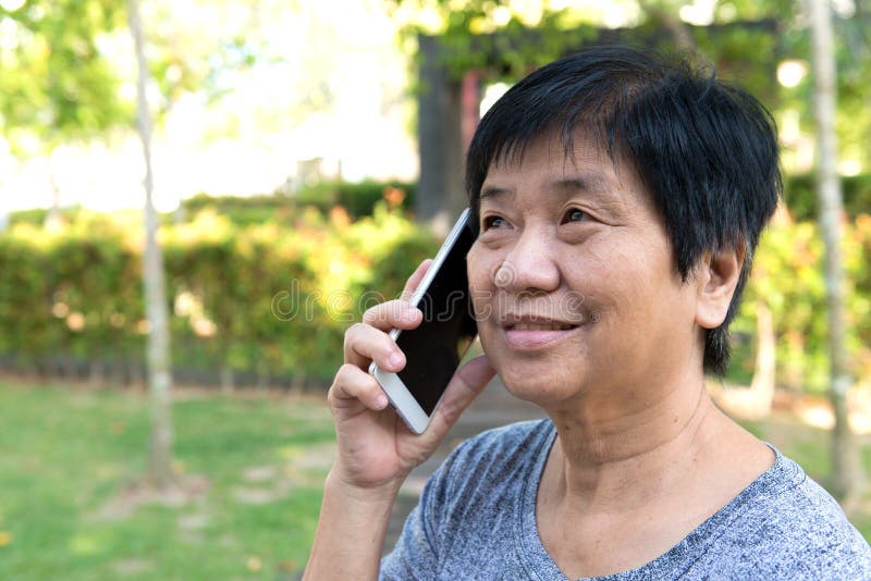 Senior woman talking on smart phone stock photo