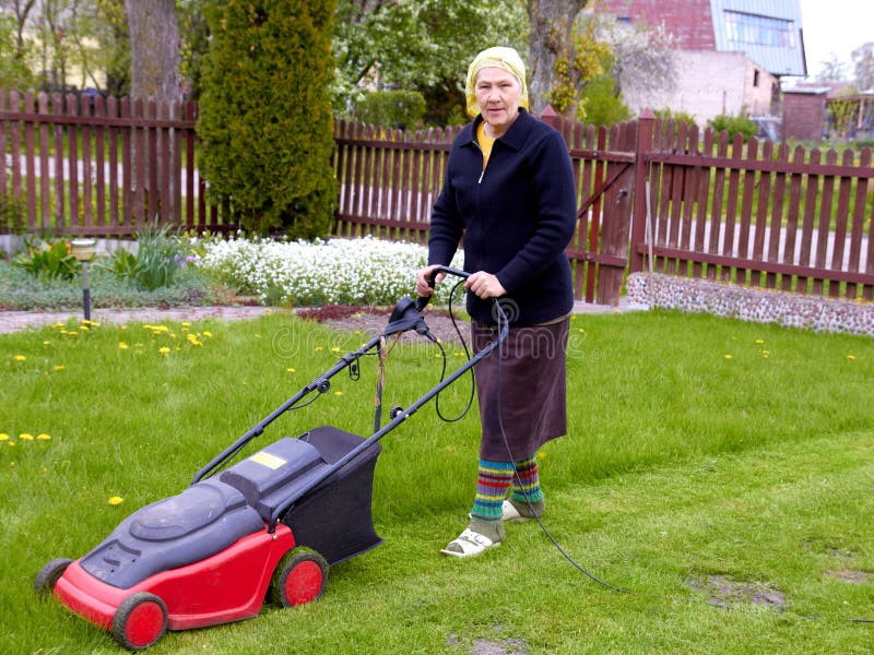 Senior woman working with lawn mower