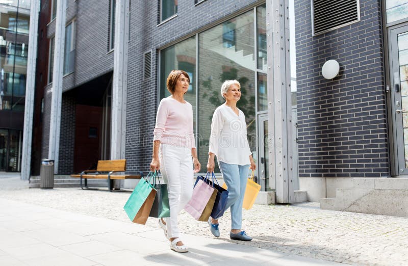 Senior women with shopping bags walking in city stock photography Senior women with shopping bags walking in city stock photography