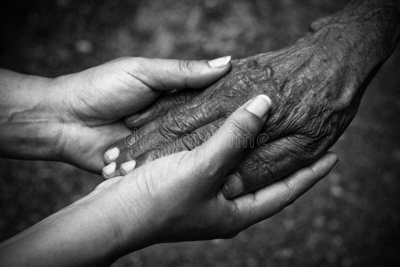 Senior and young holding hands with black and white effect