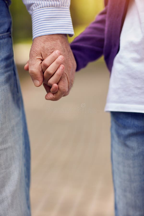Senior and Young Holding Hands Walking Stock Photo Image of