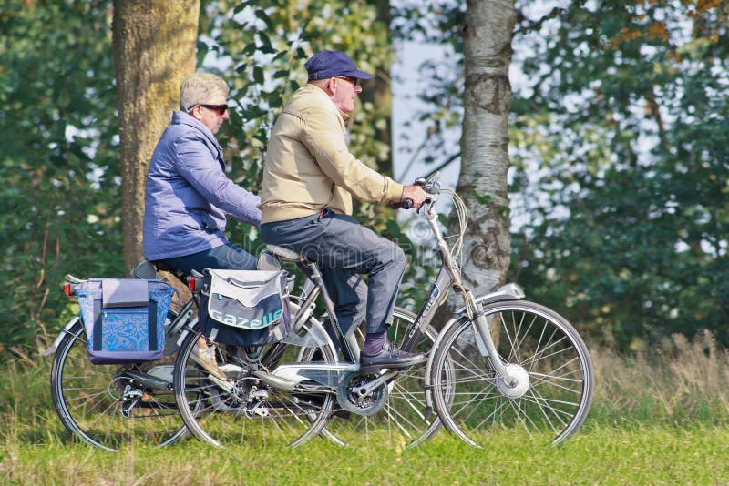 Seniors on e-bikes having a ride, Tilburg Netherlands royalty free stock images Seniors on e-bikes having a ride, Tilburg Netherlands royalty free stock images