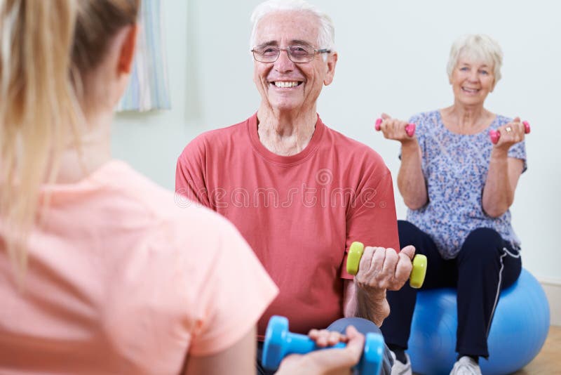 Seniors At Fitness Class With Instructor royalty free stock images