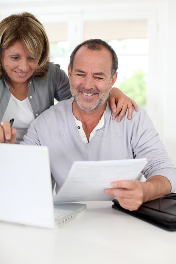 Seniors at home doing paperwork royalty free stock images Seniors at home doing paperwork royalty free stock images