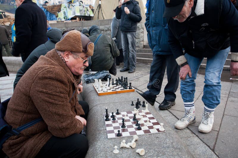 Seniors play chess on the street