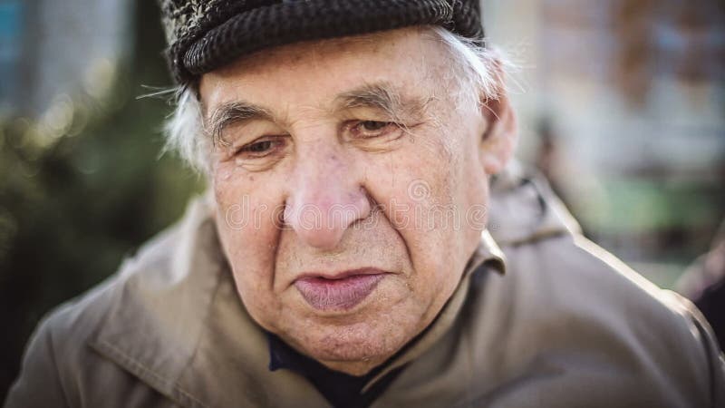 Seniors portrait, sad elderly man looking at camera