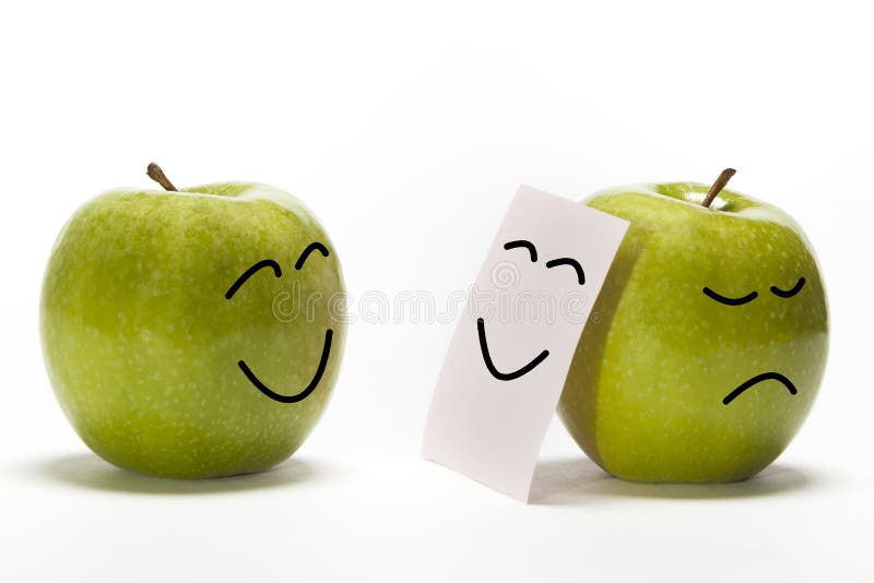 An apple smiling to other one, that is concealing its sadness behind a smily mask. An apple smiling to other one, that is concealing its sadness behind a smily mask