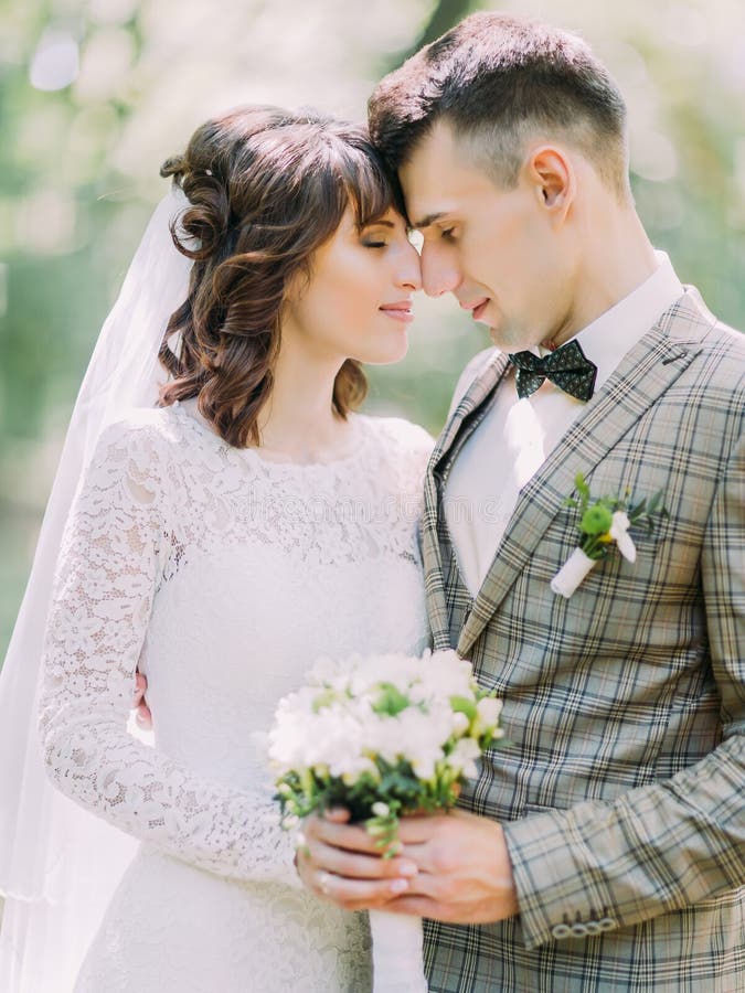 The Sensitive Side Portrait Of The Newlyweds Petting Each Other Faces