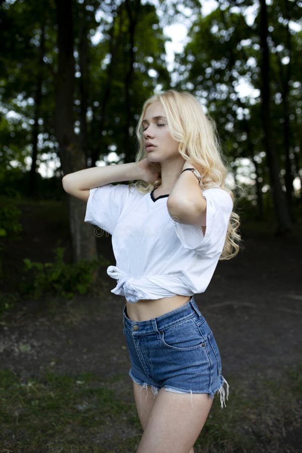 Closeup of a Blonde Young Woman with Closed Eyes Holding Her Hands ...