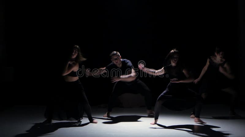 Sensual contemporary dance moves of five dancers on black, shadow