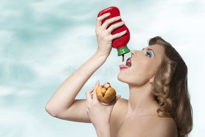 sensual-girl-ketchup-fashion-glutton-young-blonde-curly-hair-eating-hot-dog-putting-tomato-her-mouth-41234684.jpg