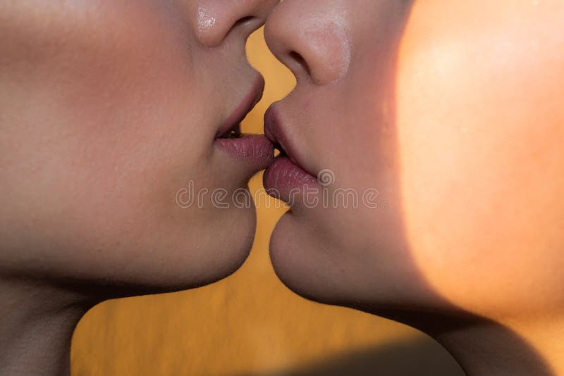 Sensual girls couple kiss, close up. Young female Woman kissing. Affection LGBT. Beautiful macro female lips. Sensual girls couple kiss, close up. Young female