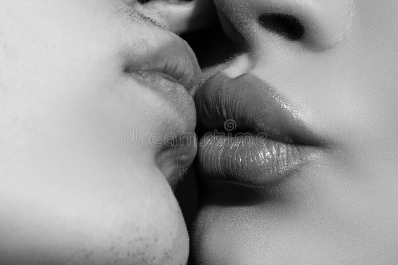Sensual kiss close up. Close-up two lips kissing sensual intimate, young man woman kiss.