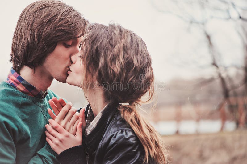 Sensual portrait of young loving couple kissing on the walk in early spring